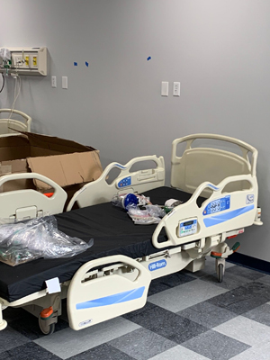 New hospital bed being professionally assembled and installed